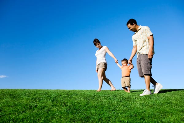 Family walking on grass